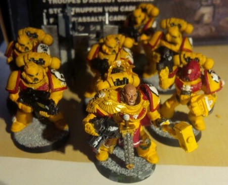Space Marine Captain leading a small tactical squad of Imperial Fists Marines