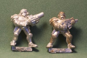 eBay picture of two Adeptus Arbites models I won. One has a bolter and the other has a grenade launcher